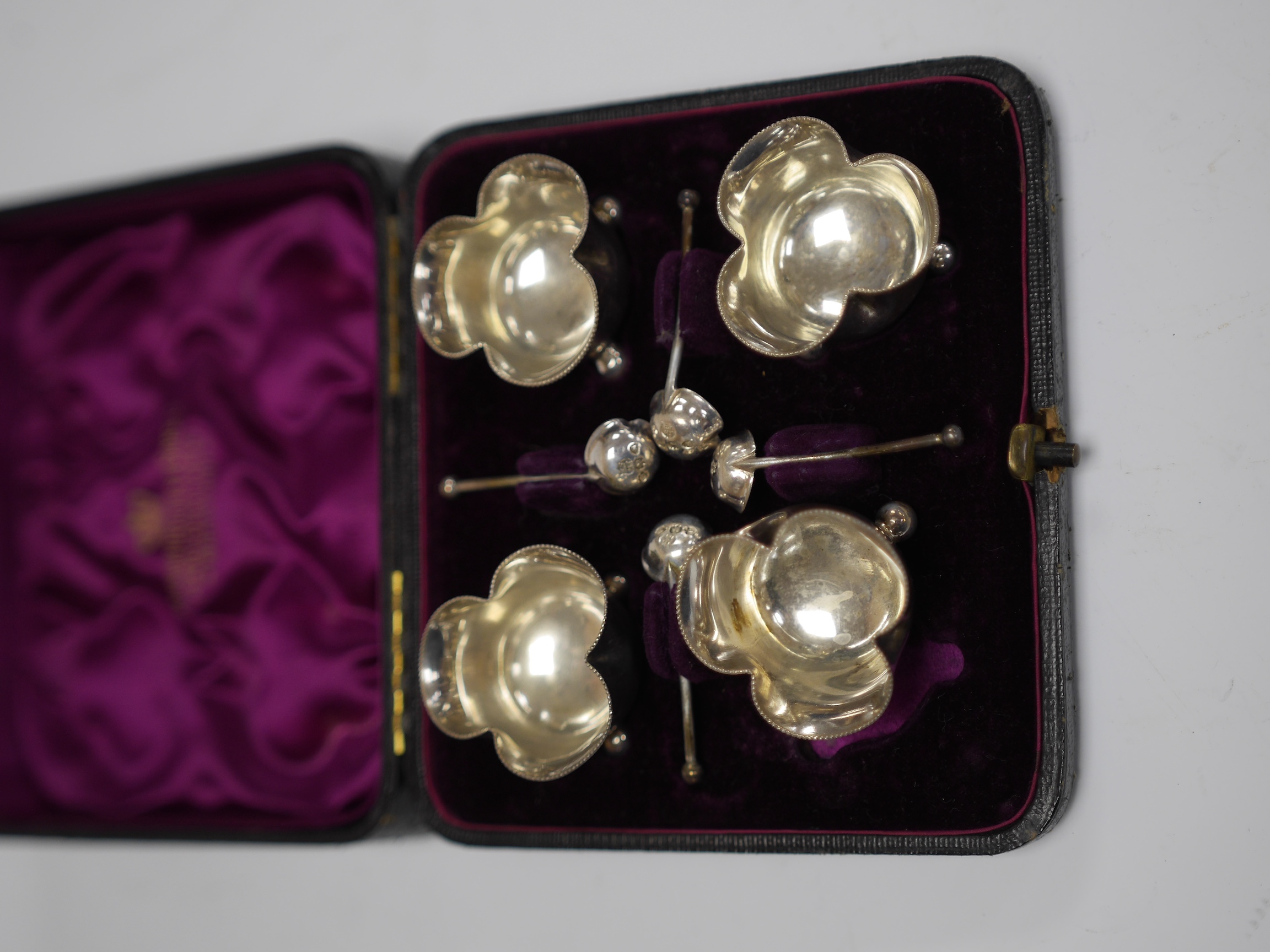 A cased set of four late Victorian silver salts and matching spoons, Horace Woodward & Co, London, 1890. Condition - fair to good